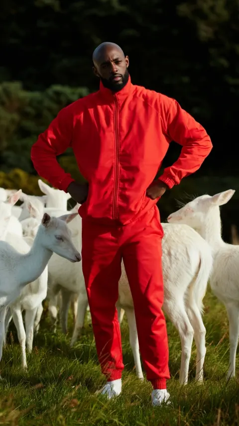 A youthful athletic bald black man with a sunny disposition, Hands on hips, shoulders back