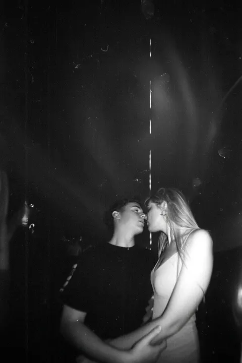 Lovers looking at each other, embracing, storm, hurricane swirl funnel overhead, fisheye lens
