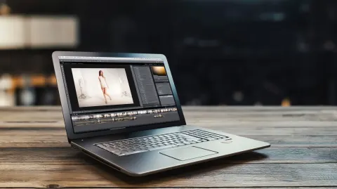 Hyper-sharp macro shot of a sleek laptop screen displaying a photo editing software interface with a