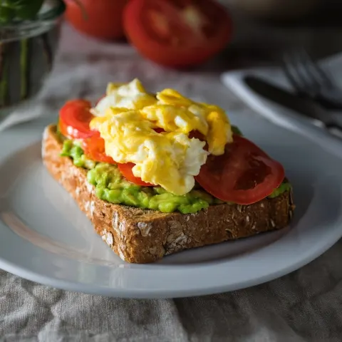 Wholemeal toast with avocado, scrambled eggs and tomato. Food photography. Bird's-eye view