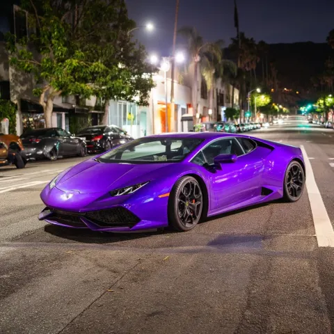 Purple crashed lamborghini in a los angeles street at night