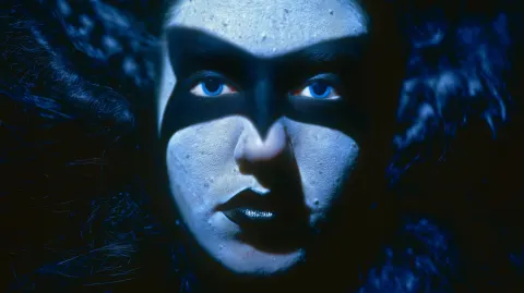 Ultra-photorealistic extreme close-up portrait of a mysterious woman with piercing icy blue eyes
