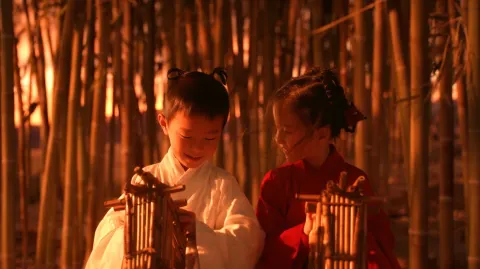A premium cinematic close-up of a young ancient Chinese boy in white and a young ancient Chinese gir