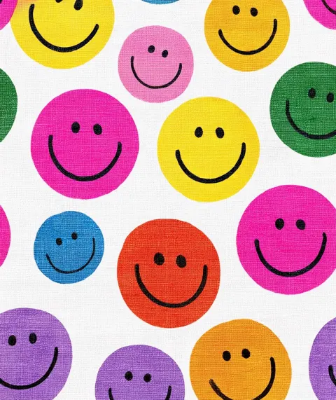 A pattern of colorful smiley faces on white linen fabric