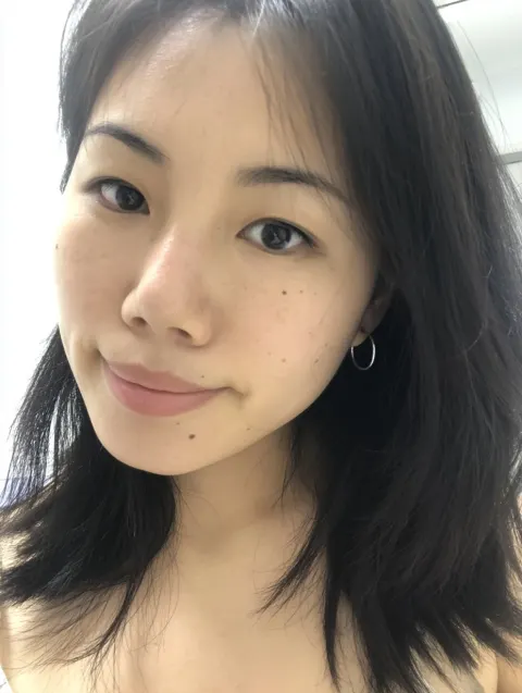 A selfie of a beautiful Shanghai lady with medium - length black hair. The subject is a woman in her