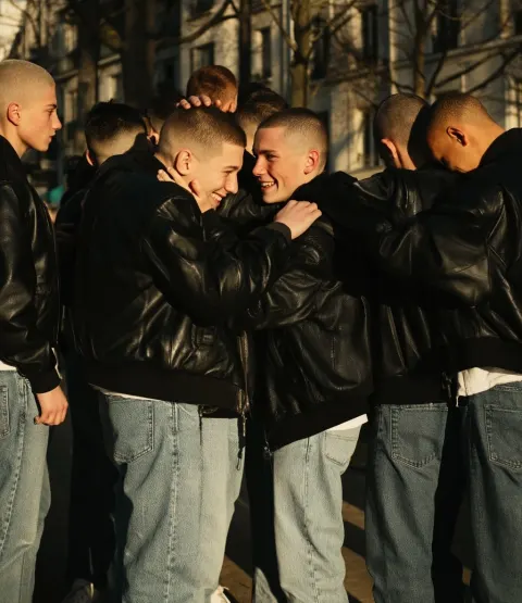 Gang of teenage boys, in love with each other, hugging, smile, black leather bomber jackets