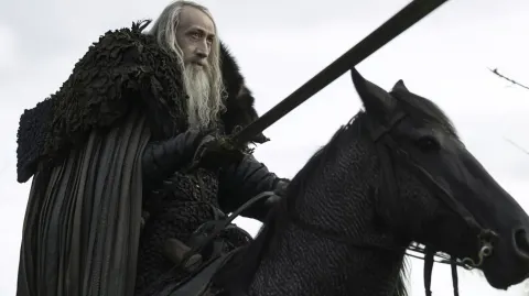 A mighty warrior riding a horse