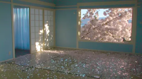 An empty Japanese Showa-era apartment room, worn tatami mats and old sliding glass doors
