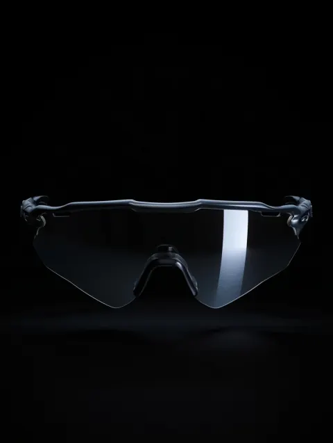 A cinematic super close-up product shot of gray OAKLEY Zeros wraparound sunglasses floating in a pit