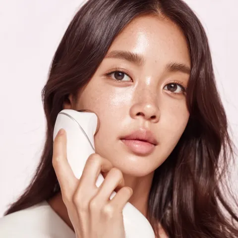 Young Model Using a Skincare Device