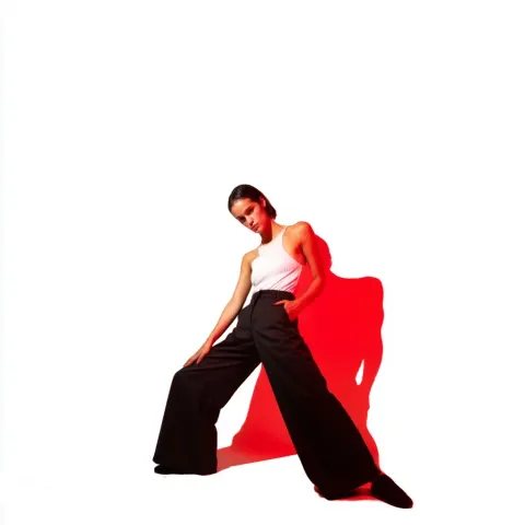 White background, with a fashion magazine vibe. A model striking a simple pose