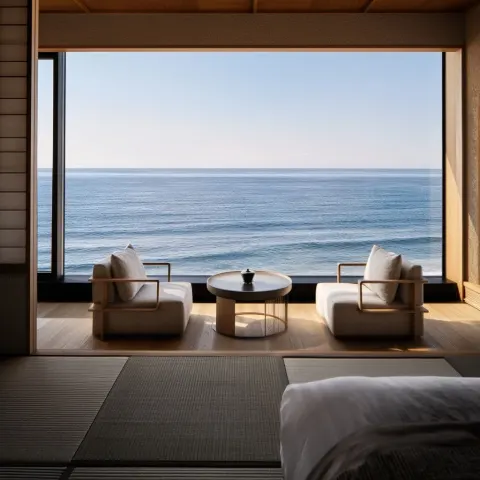 Luxury Japanese ryokan suite interior with ocean view through large open window
