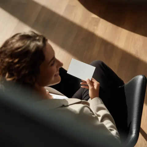 Please create a high-end luxury image of a sophisticated woman in a Mercedes-Benz dealership