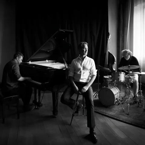 Album photo shoot of a nordic jazz trio. three men around the age of 40. small studio, piano