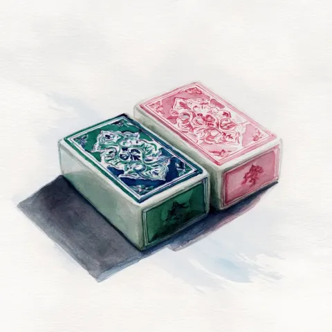 A watercolor drawing of two mahjong tiles lying flat on a table but instead of traditional red and g