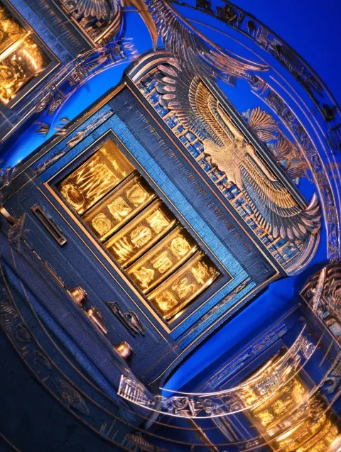 Dynamic foreground of ancient Egyptian-themed slot machines, glowing gold symbols