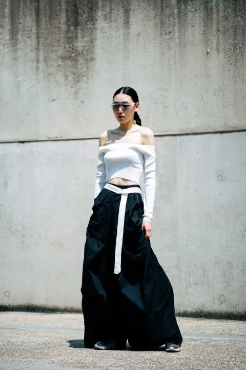 Luxury editorial street casting photo, real Korean woman in her 20s, strong memorable face