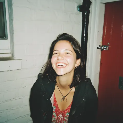 Create a photo of a pretty girlfriend taken by her boyfriend. The girlfriend is smiling nicely