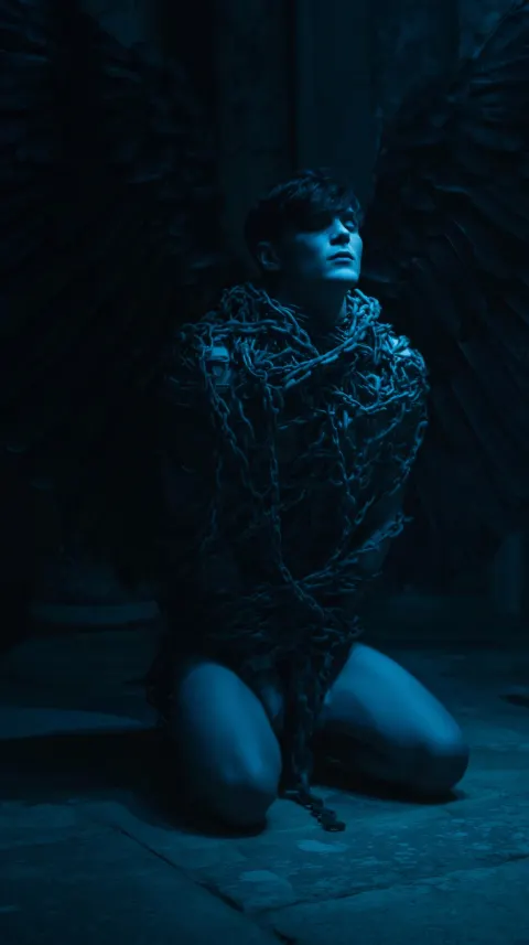 Thanatos from Greek mythology bound tightly in heavy iron chains
