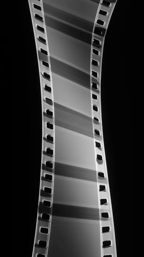 Perfectly straight vertical film strip, rigid, no deformation, no curvature at all, flat 2D