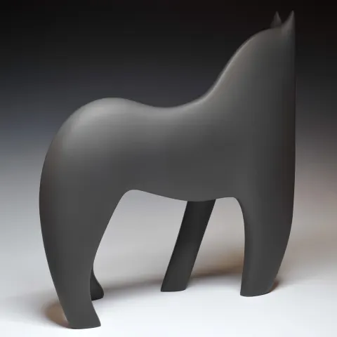 A black sculpture of an abstract horse, with its back to the camera
