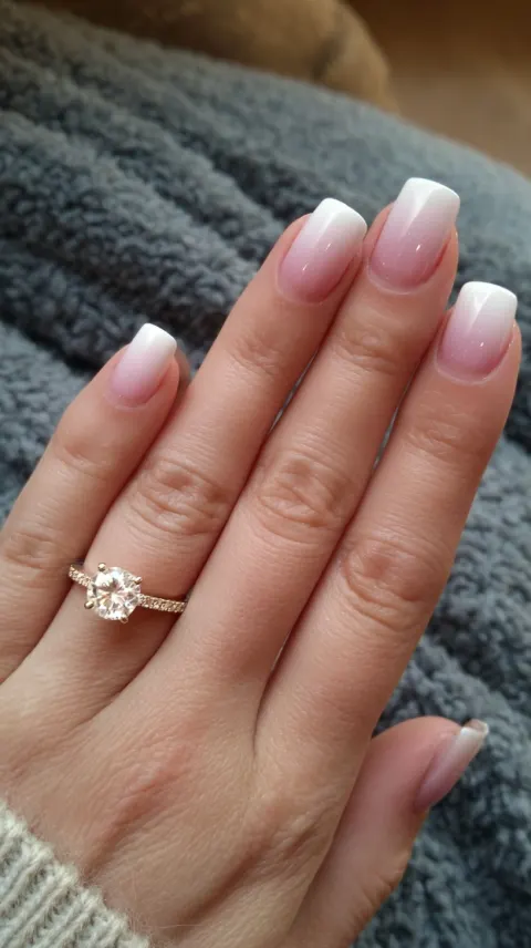 A photo of white and pink ombre nails with square-shaped tips