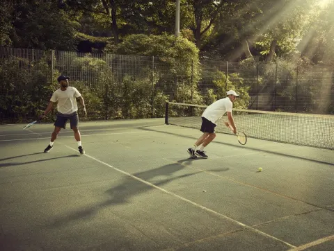 Billboard photography, soft natural lighting, two tennis players competing on the tennis court