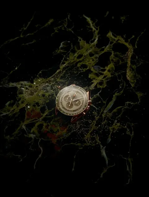 Close up of macro photo of omega speedmaster on black background