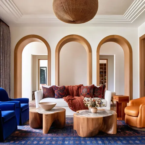 A high-end, color-rich living room blending classic and modern American elements
