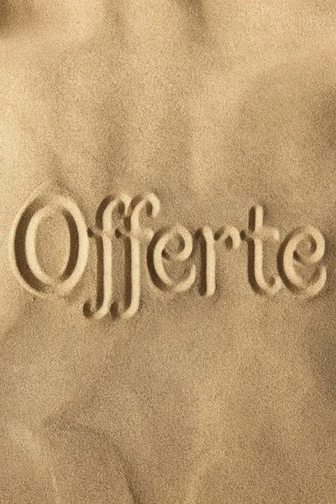 The word "Offerte" is carved into the sand, in a light brown color, ultrarealistic.