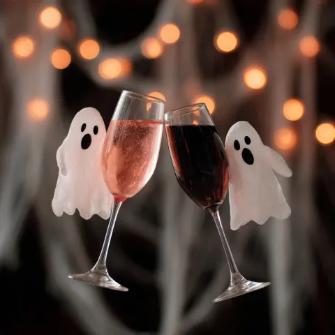 Two glasses clinking in air (one pink and one black) suspended in air (like they are being held by g