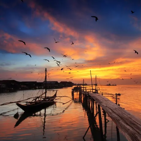 The most beautiful sunset view from a malay wooden fisherman village ,prau on water