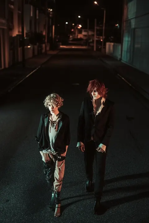 Photograph of two attractive man, Nick and Ludger walking in empty street in midnight