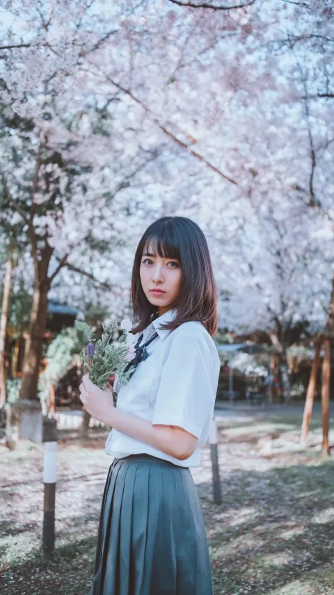 Cherry Blossom Petals and a Girl Holding Flowers