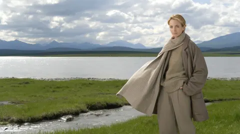 High-end fashion editorial outdoors, adult woman in minimalist earth-tone outfit