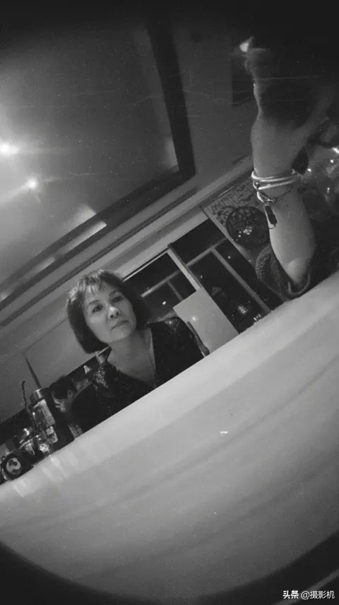 Pinhole Camera View of a Woman at a Table