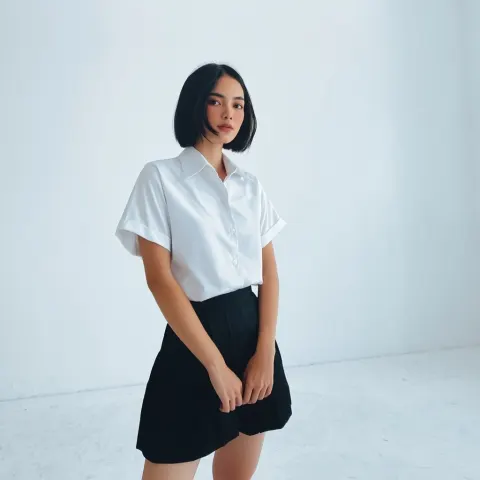 Beautiful asian girl short hair , short skirt , in white empty room